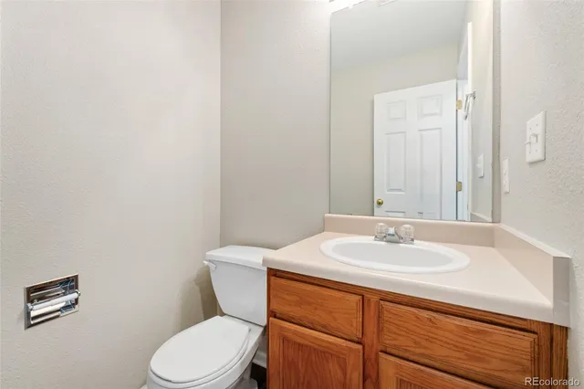 a bathroom with a sink a toilet and mirror