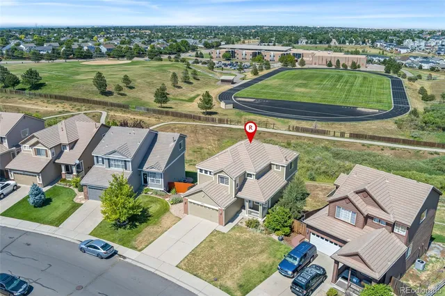 an aerial view of a house with outdoor space and lake view