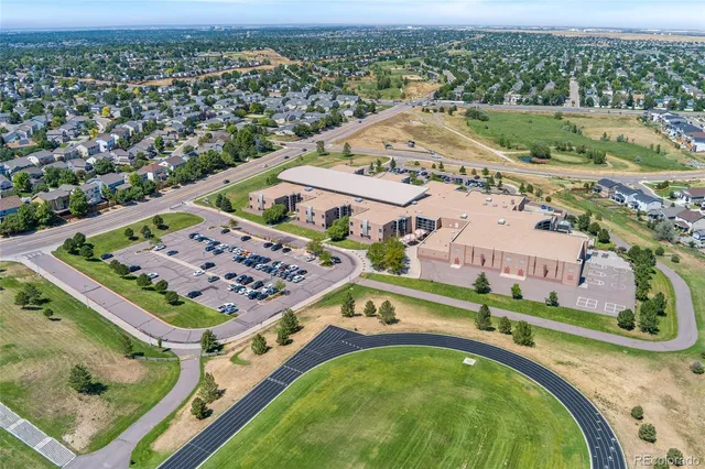 an aerial view of a swimming pool with a yard