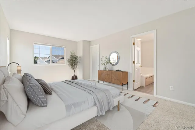 a bedroom with a bed and a mirror