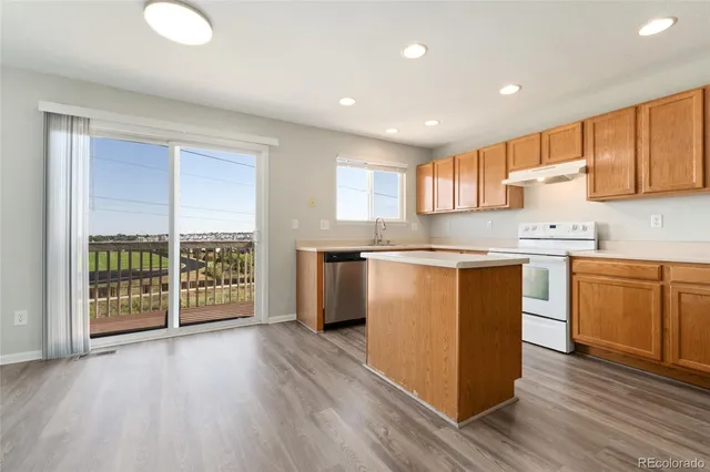 a kitchen with stainless steel appliances granite countertop a stove and a refrigerator