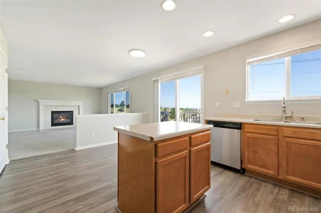 a kitchen with a sink cabinets and wooden floor