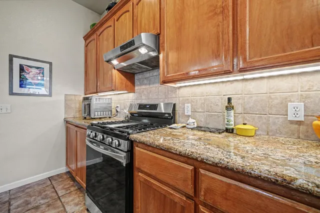 a living room with furniture a chandelier and a fireplace