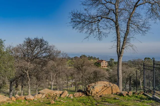 a view of a house with a mountain and a forest
