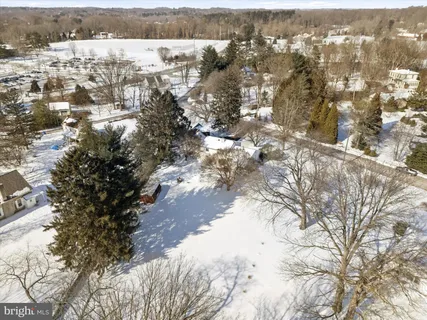 a front view of a house with porch and garden