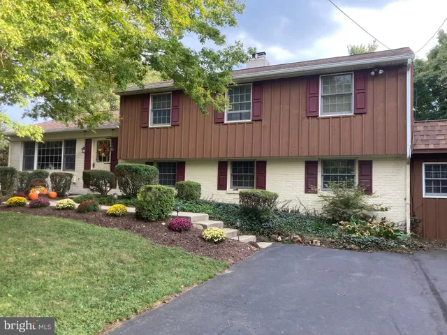 a view of swimming pool with lawn chairs and plants