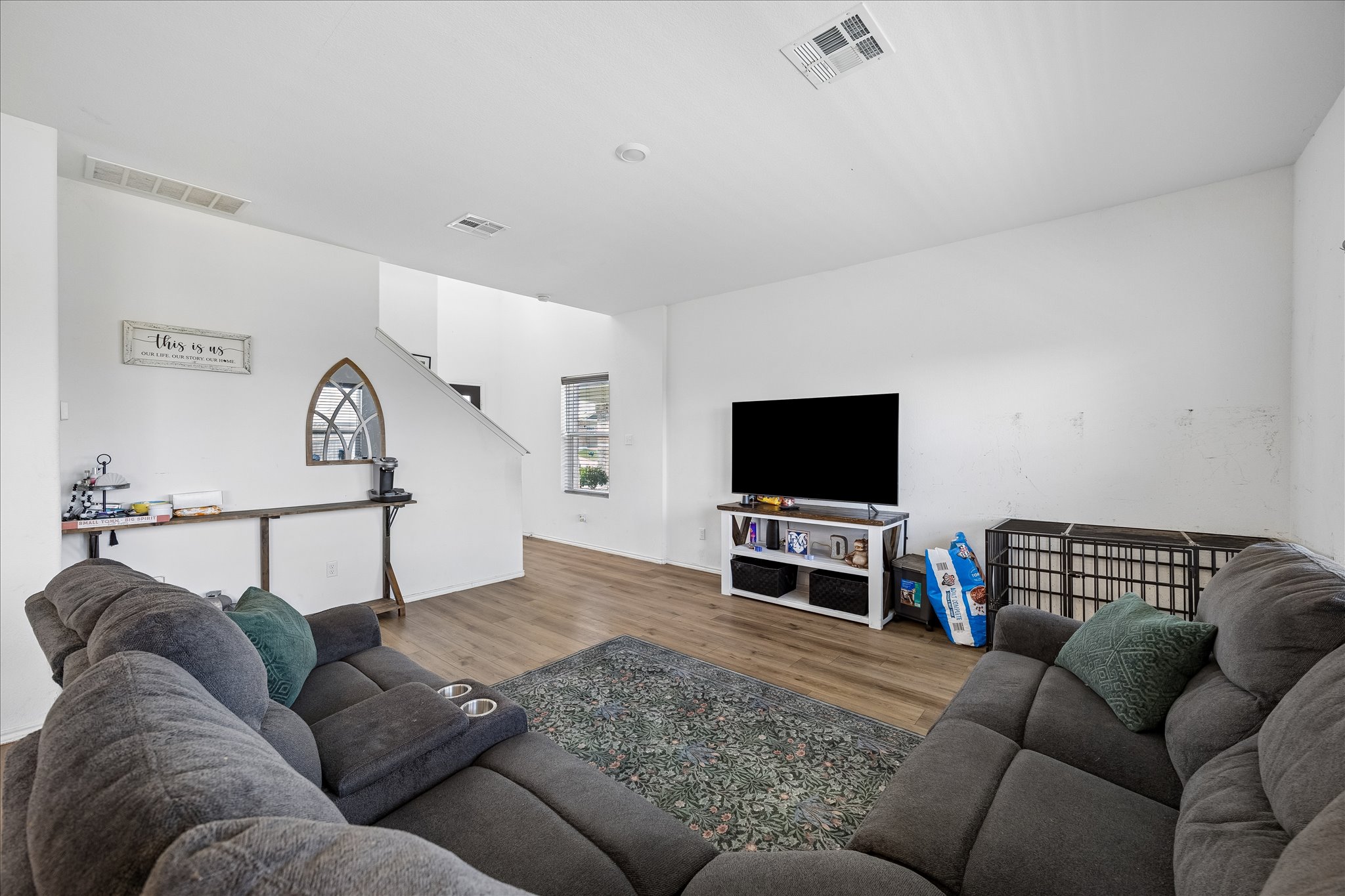217 Canley Loop Hutto, TX 78634 - Photo 13 of 36 Laminate flooring connects an open living area to the stairs, perfect for gatherings.