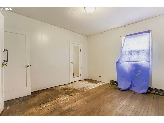 a view of an empty room and wooden floor