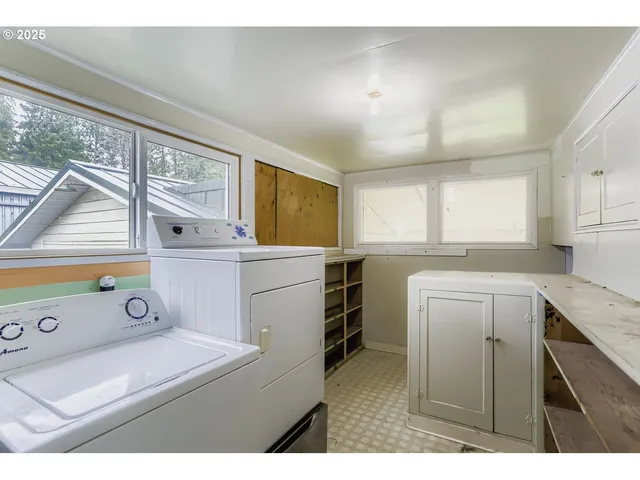 a utility room with closet dryer and washer
