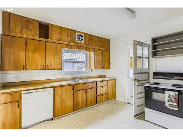 a kitchen with stainless steel appliances granite countertop a sink stove and cabinets