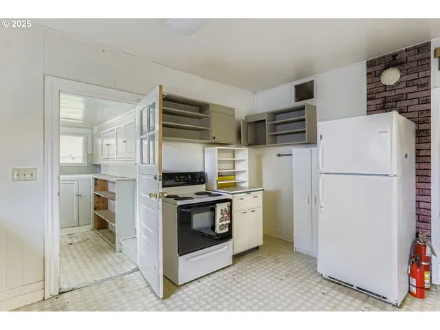 a kitchen with stainless steel appliances a refrigerator sink and stove
