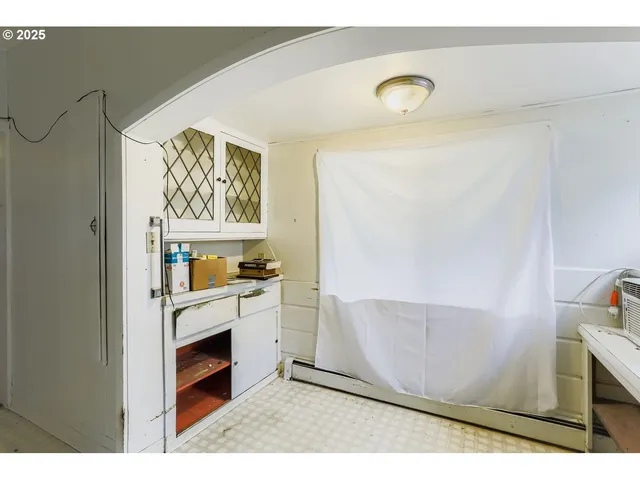 a view of kitchen with microwave and cabinets