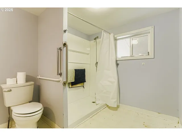 a bathroom with a toilet sink and shower
