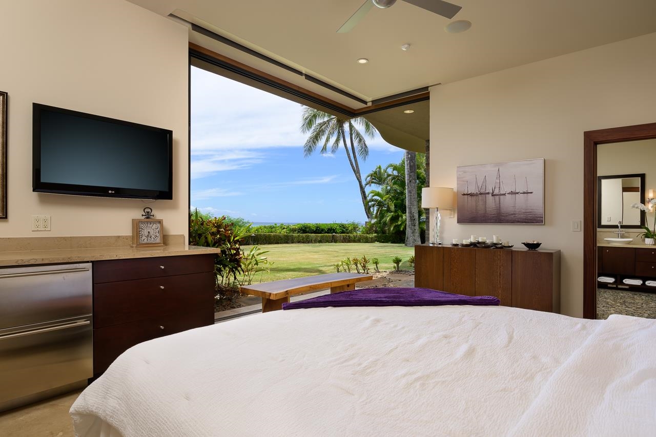 4809 Lower Honoapiilani Road Lahaina, HI 96761 - Photo 37 of 49 a bedroom with a bed and a flat screen tv
