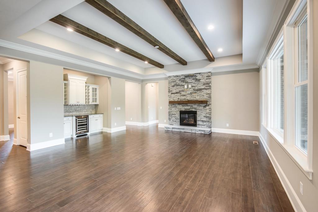 5000 Weatherford Pass, Unit 102 Franklin, TN 37064 - Photo 14 of 29 an empty room with wooden floor and fireplace