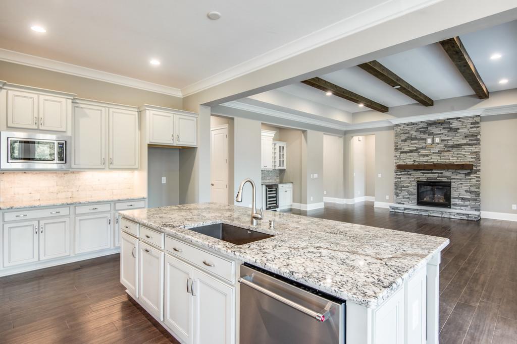 5000 Weatherford Pass, Unit 102 Franklin, TN 37064 - Photo 15 of 29 a kitchen with granite countertop stainless steel appliances a sink stove and cabinets
