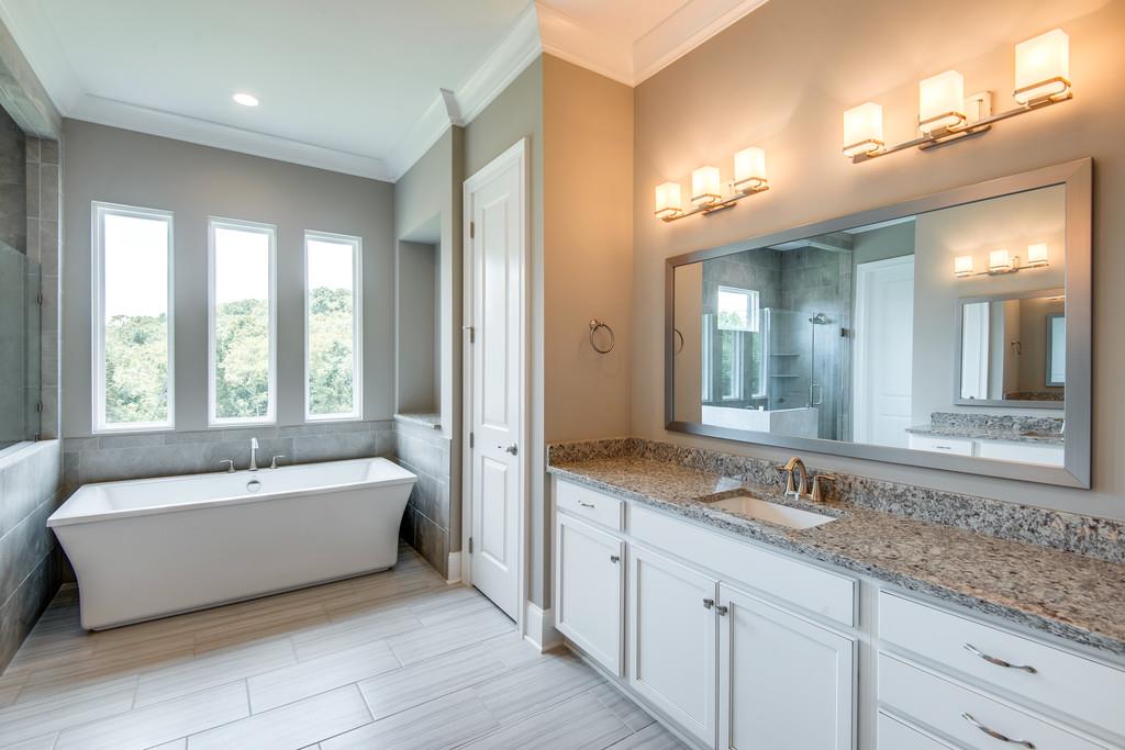 5000 Weatherford Pass, Unit 102 Franklin, TN 37064 - Photo 20 of 29 a spacious bathroom with a tub double sink and mirror