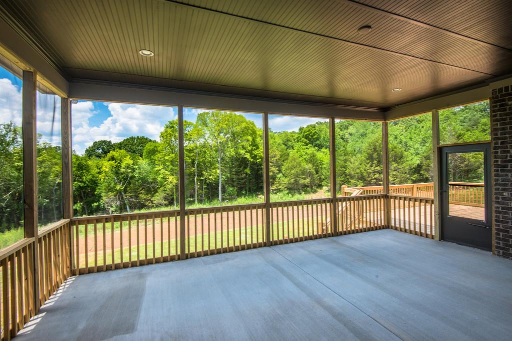 5000 Weatherford Pass, Unit 102 Franklin, TN 37064 - Photo 26 of 29 a view of a porch with wooden floor in front of a house