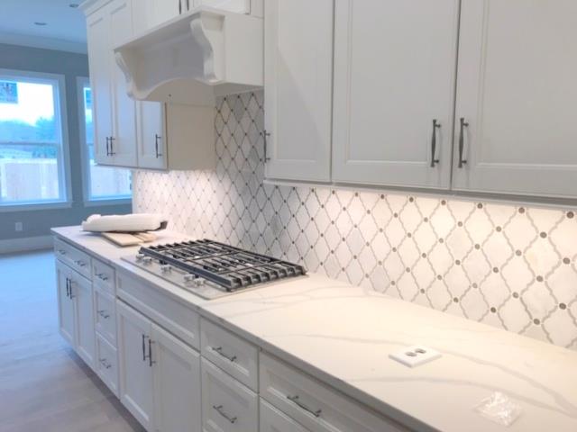 5000 Weatherford Pass, Unit 102 Franklin, TN 37064 - Photo 9 of 29 a kitchen with granite countertop white cabinets and white appliances