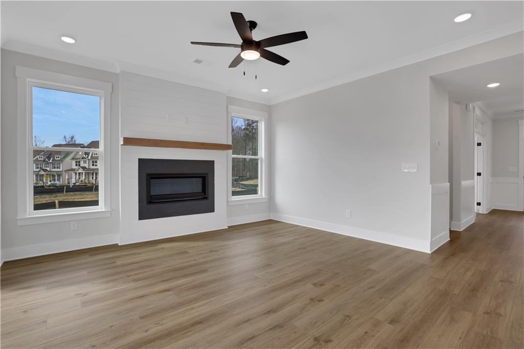 138 Marble Tree Way Ball Ground, GA 30107 - Photo 18 of 65 an empty room with windows and a fireplace