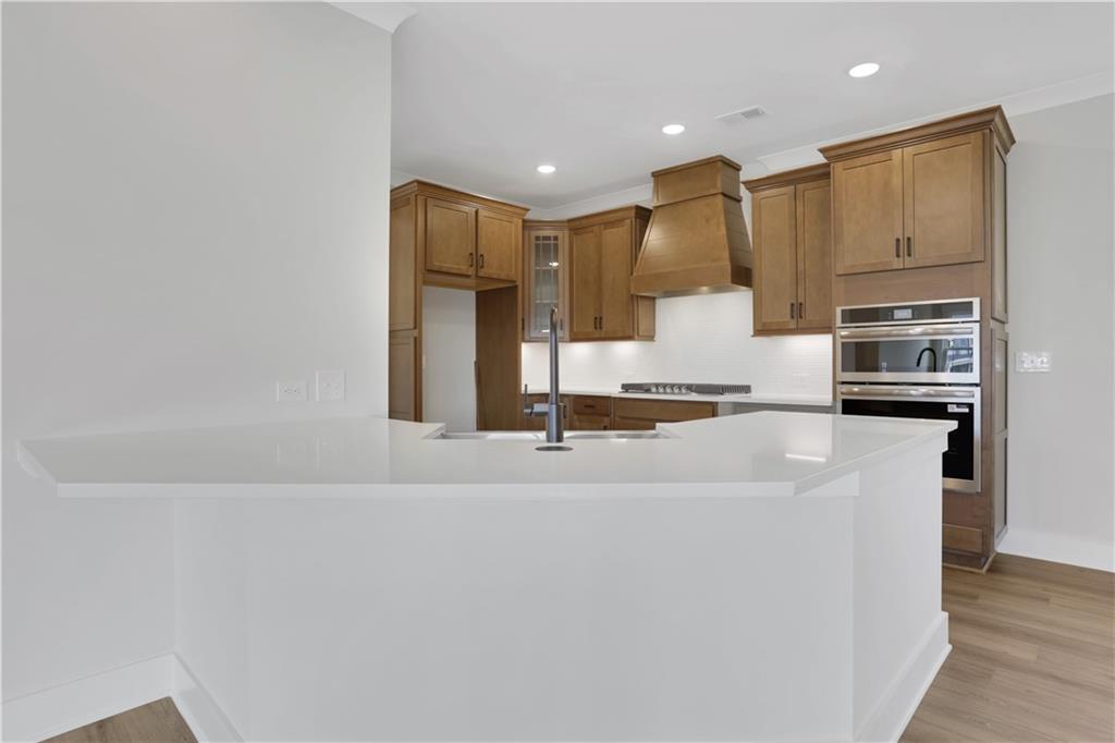 138 Marble Tree Way Ball Ground, GA 30107 - Photo 21 of 65 a large kitchen with a large counter top appliances and cabinets