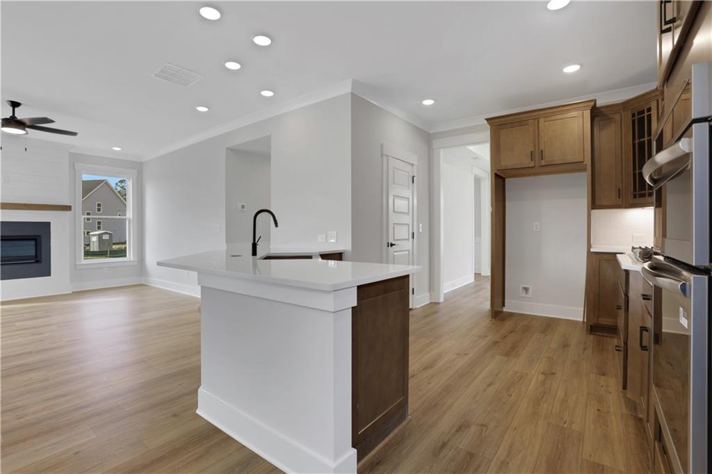 138 Marble Tree Way Ball Ground, GA 30107 - Photo 22 of 65 a kitchen with stainless steel appliances granite countertop a refrigerator a stove and a wooden floors