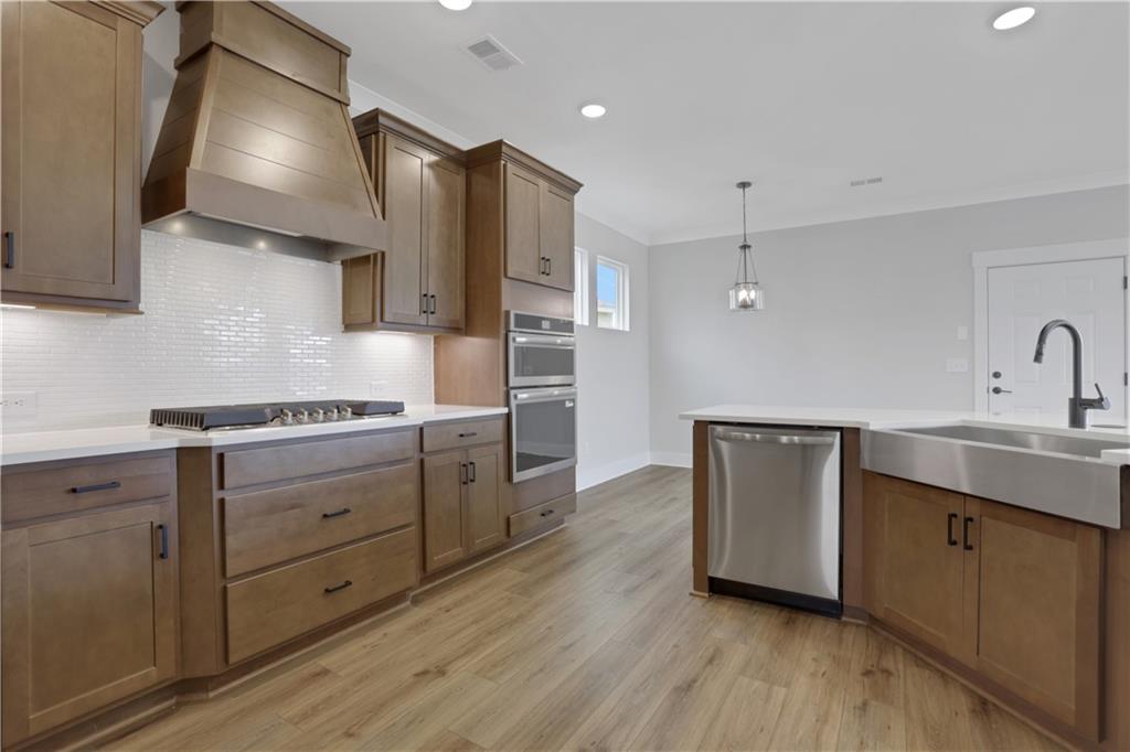 138 Marble Tree Way Ball Ground, GA 30107 - Photo 26 of 65 a kitchen with a sink stainless steel appliances and cabinets