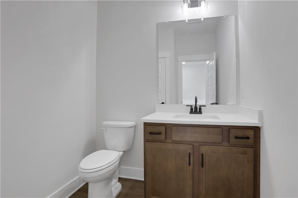 138 Marble Tree Way Ball Ground, GA 30107 - Photo 29 of 65 a bathroom with a sink toilet and a mirror