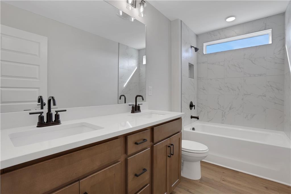 138 Marble Tree Way Ball Ground, GA 30107 - Photo 43 of 65 a bathroom with a sink a toilet and shower