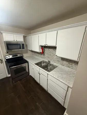 a kitchen with a stove and a sink