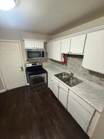 a kitchen that has a sink and a stove
