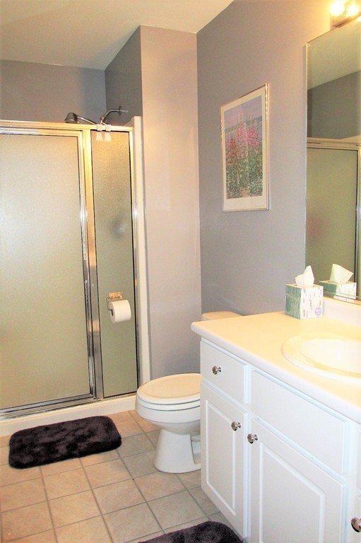 330 Sunderland Road, Unit 95 Worcester, MA 01604 - Photo 11 of 24 a bathroom with a granite countertop sink toilet and shower