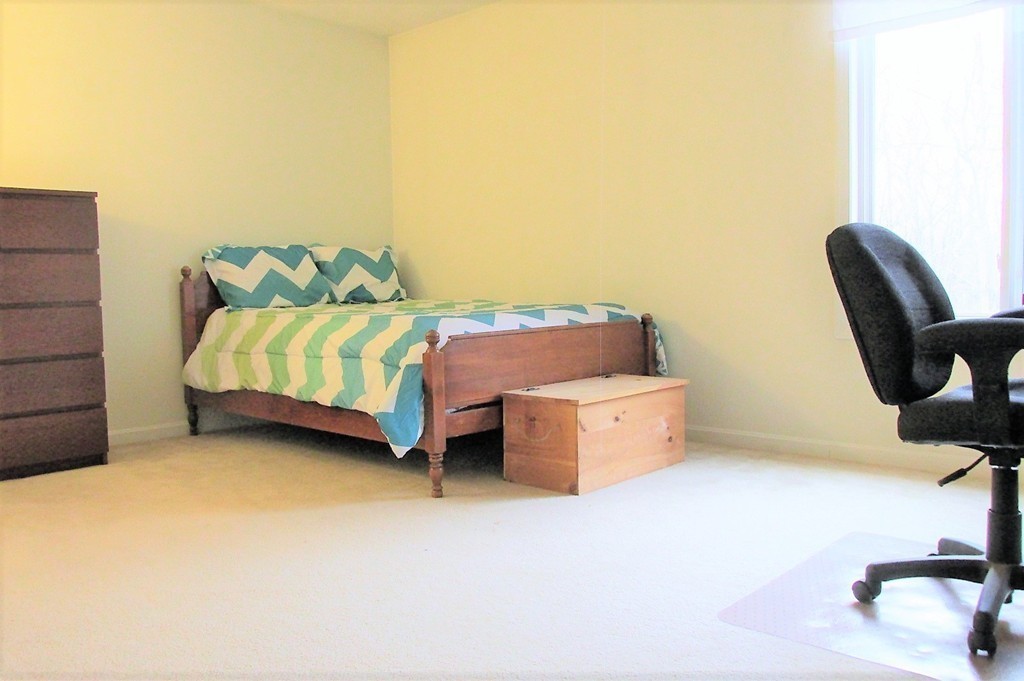 330 Sunderland Road, Unit 95 Worcester, MA 01604 - Photo 12 of 24 a bedroom with a bed and chair
