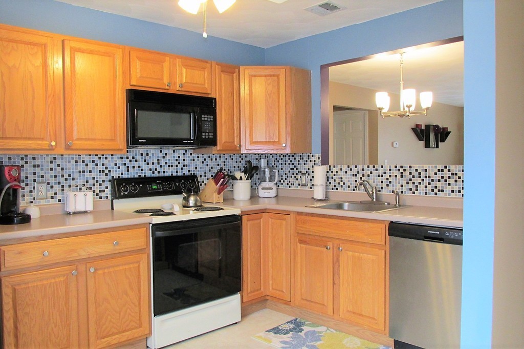 330 Sunderland Road, Unit 95 Worcester, MA 01604 - Photo 6 of 24 a kitchen with stainless steel appliances granite countertop a sink stove and cabinets