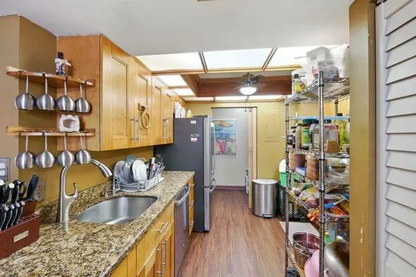 a kitchen with a refrigerator and a sink