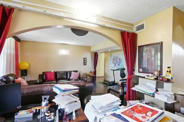 a living room with lots of furniture and a lamp