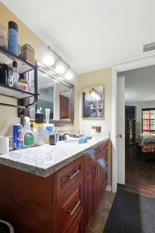 a kitchen with granite countertop a sink and cabinets