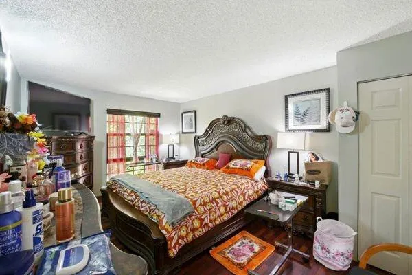 a bed room with a bed and a window