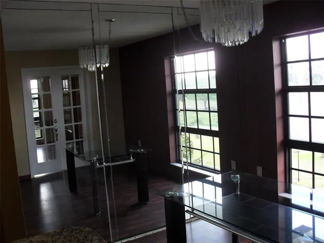 a view of a room with lots of windows and furniture