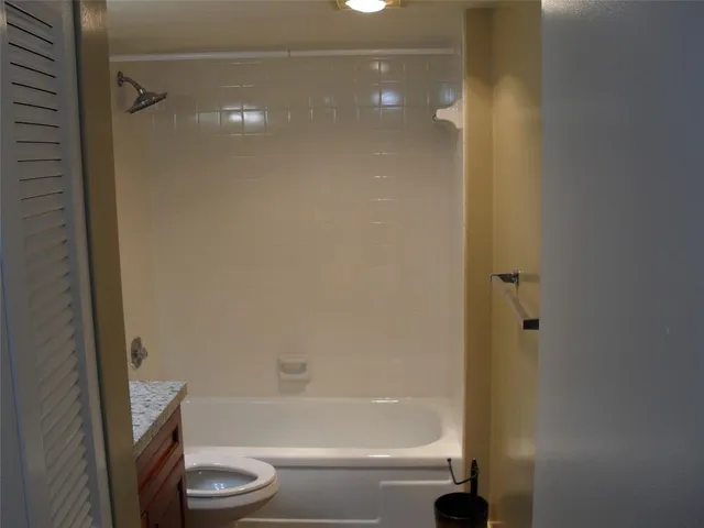 a bathroom with a bathtub and a toilet
