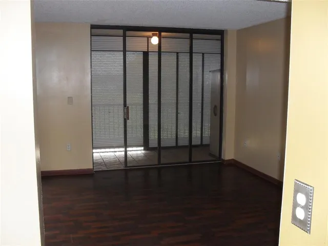 a view of wooden floor and windows in a room