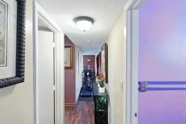 a view of a hallway with a livingroom and furniture
