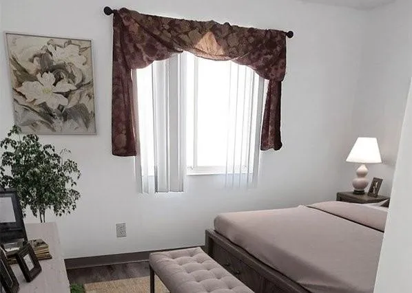 a bedroom with a bed and a window