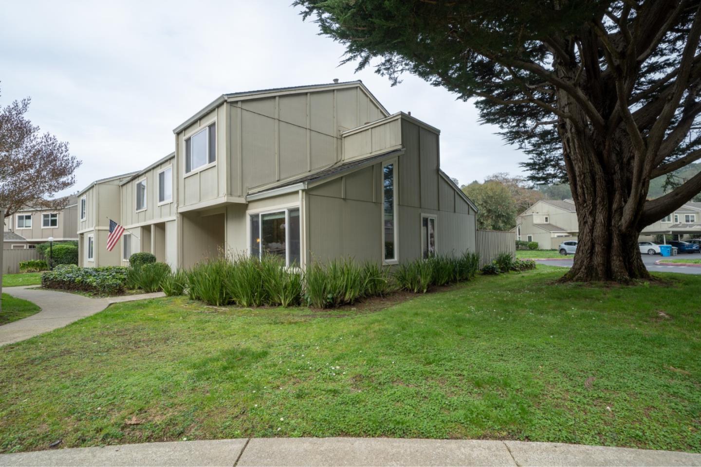 a front view of house with yard and green space