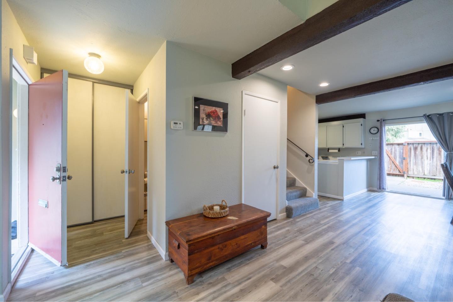 1267 Rosita Road Pacifica, CA 94044 - Photo 12 of 24 a view of a hallway with wooden floor and furniture