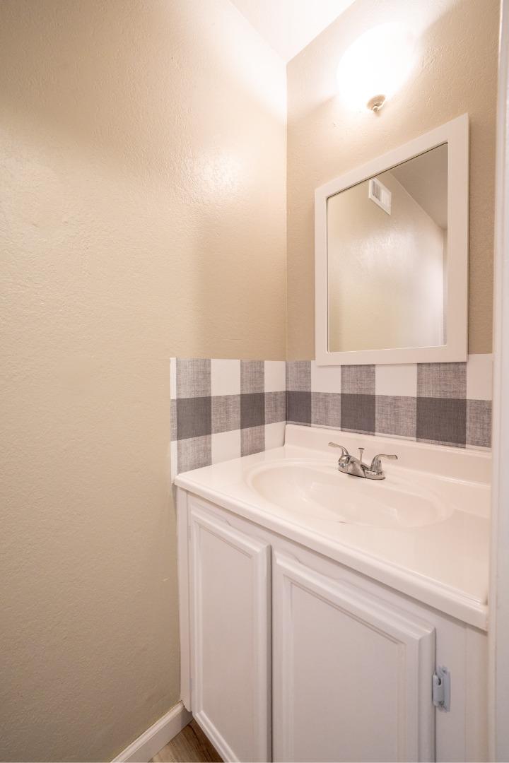 1267 Rosita Road Pacifica, CA 94044 - Photo 14 of 24 a bathroom with a sink and a mirror
