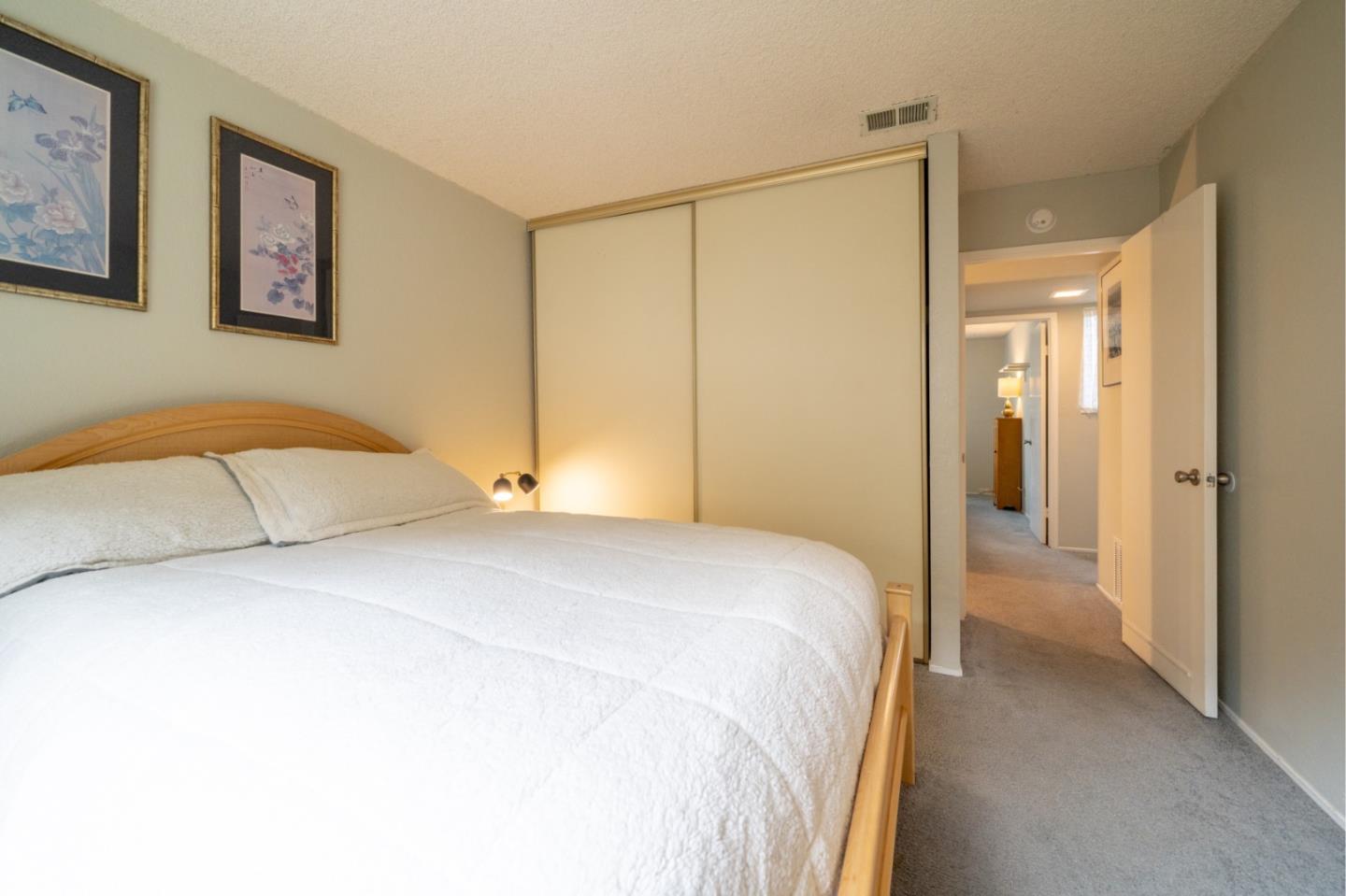 1267 Rosita Road Pacifica, CA 94044 - Photo 16 of 24 a bedroom with a bed and a painting