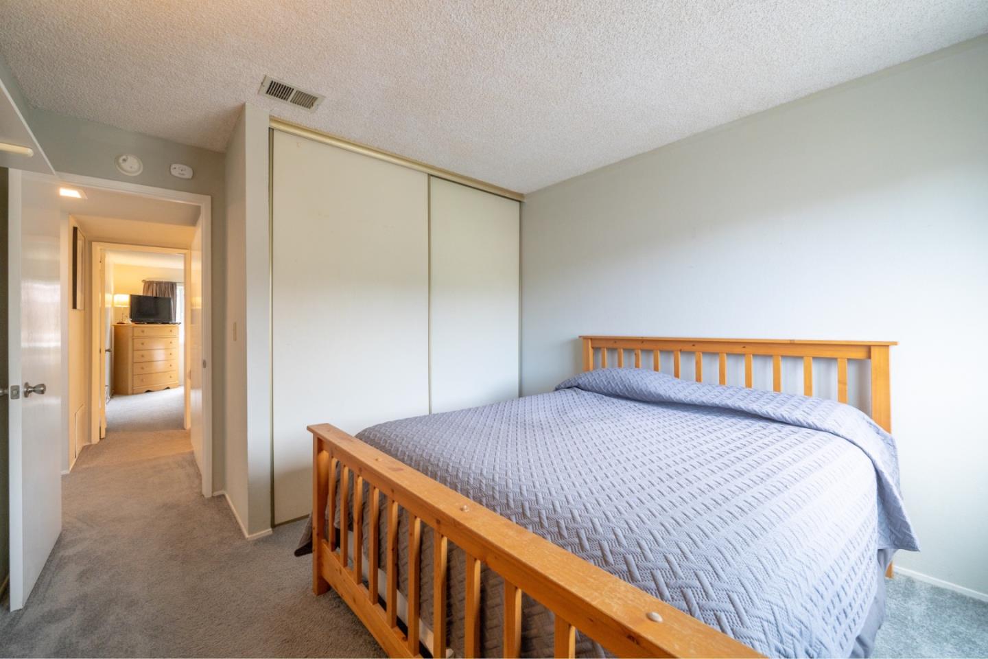 1267 Rosita Road Pacifica, CA 94044 - Photo 17 of 24 a bedroom with a bed and a lamp