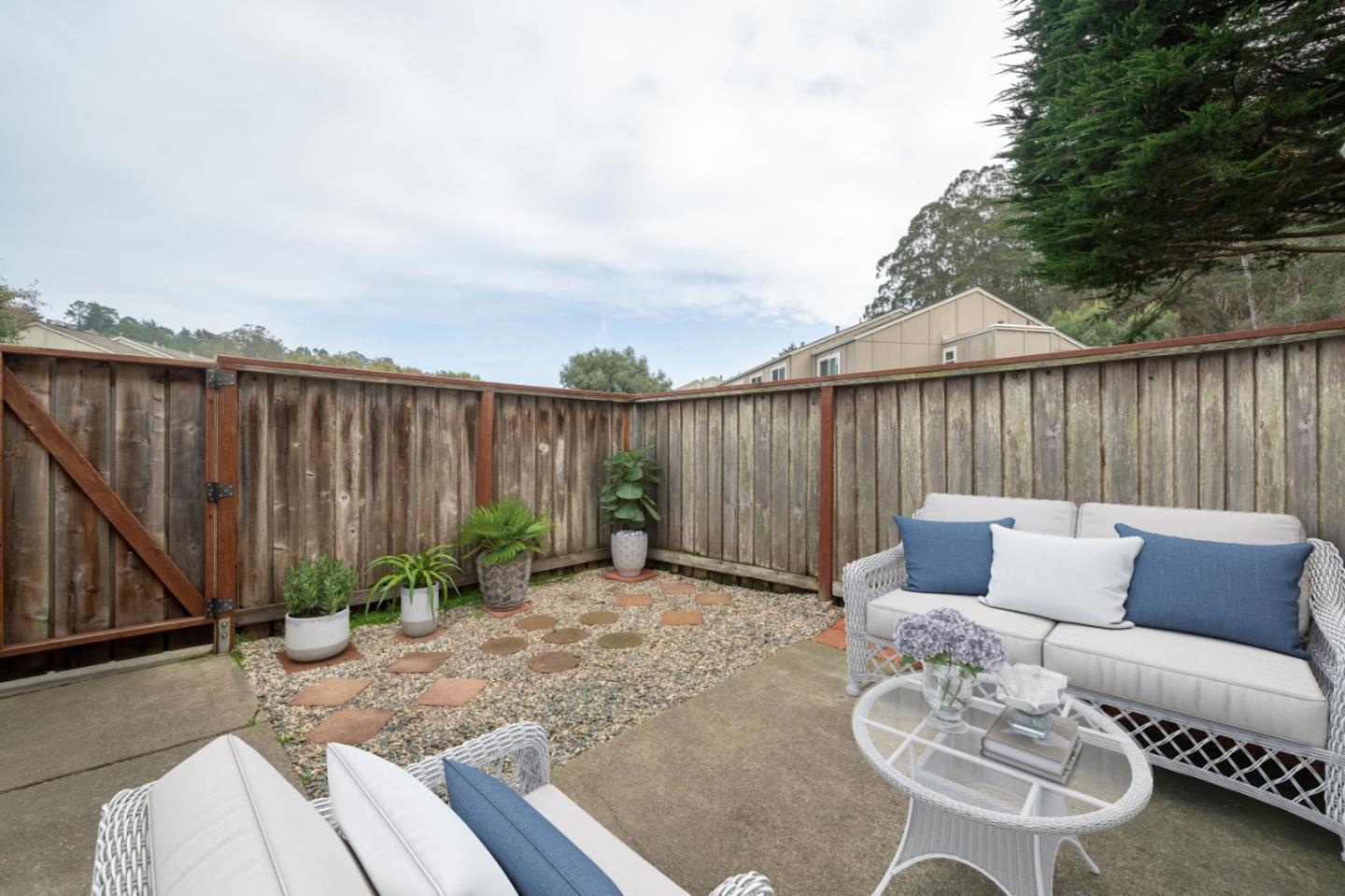 1267 Rosita Road Pacifica, CA 94044 - Photo 20 of 24 a backyard of a house with table and chairs