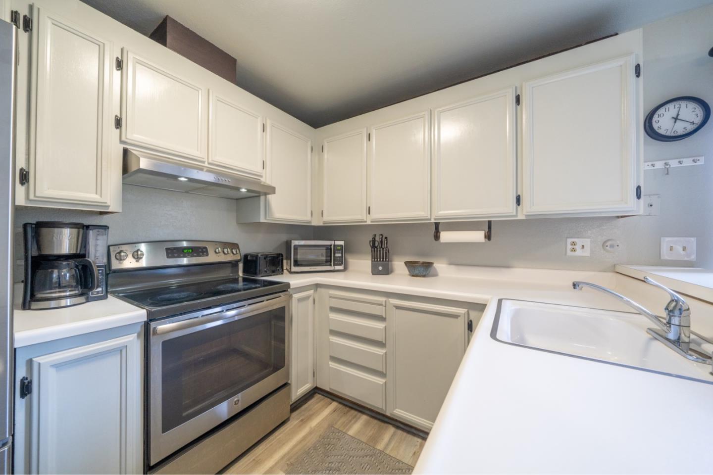 1267 Rosita Road Pacifica, CA 94044 - Photo 9 of 24 a kitchen with cabinets appliances and a sink